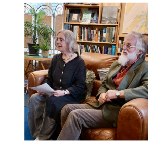 Rev Gillian sitting with author AG Rivett on a couch in a bookstore.